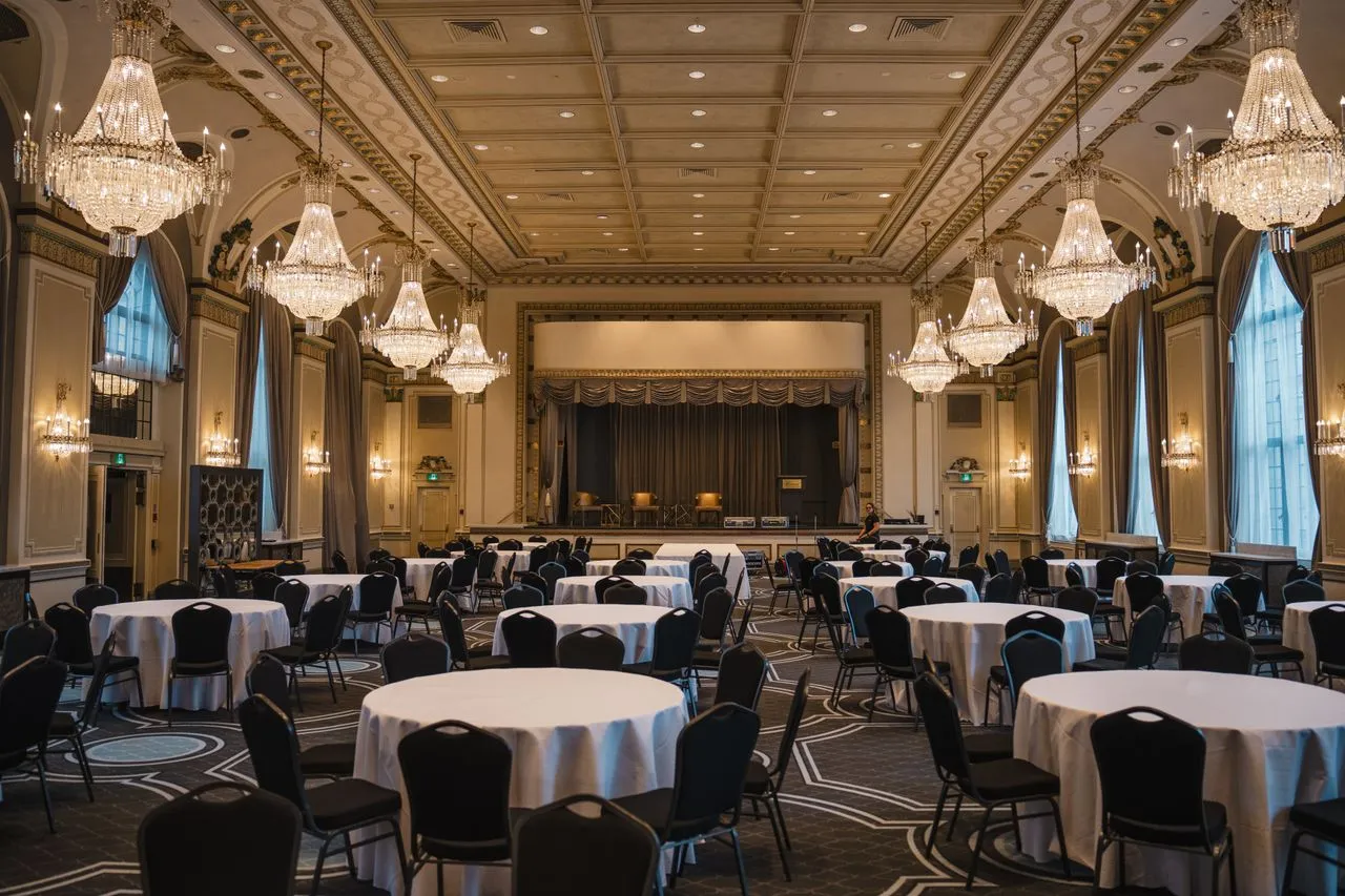 Formal reception room with coffered ceiling and round tables