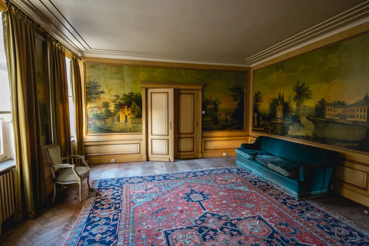 Formal room wrapped in a painted landscape mural