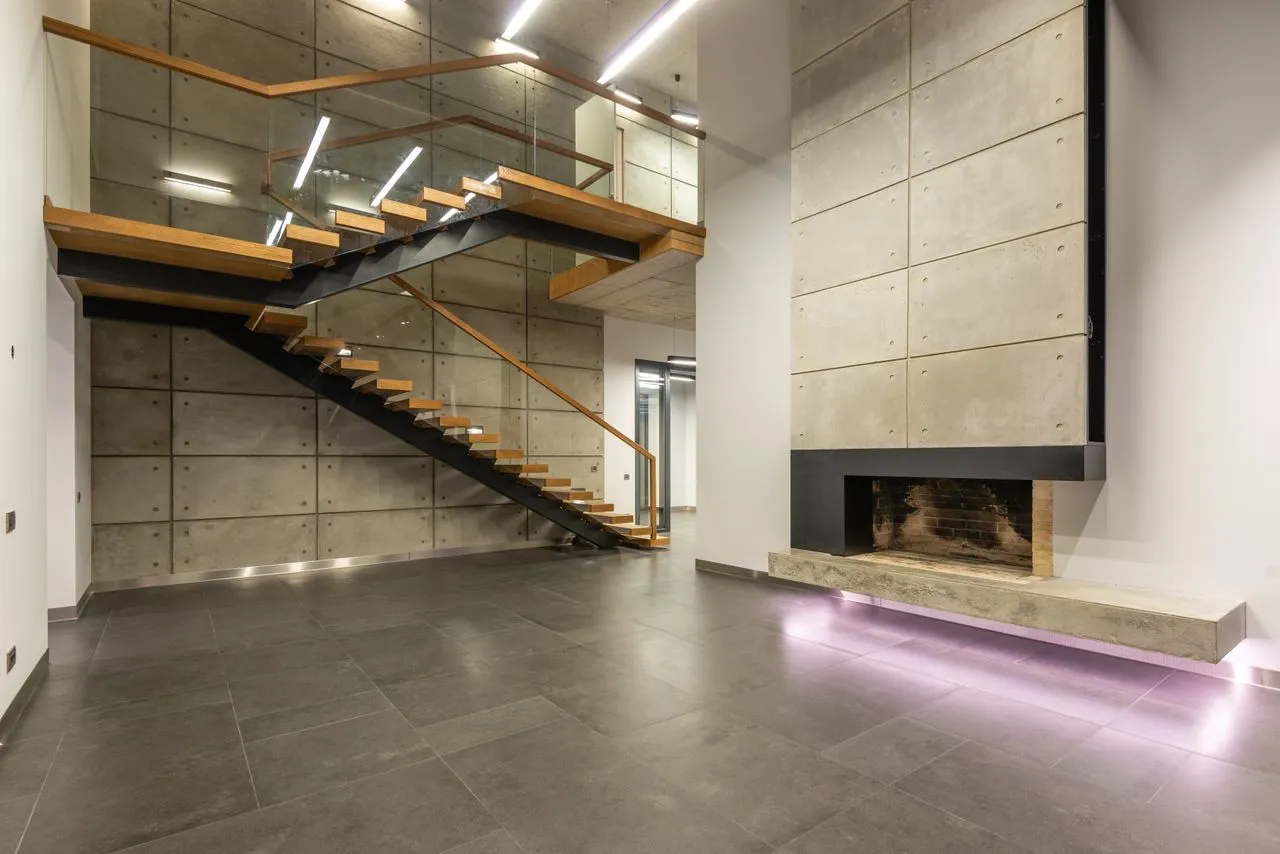 Stone interior with timber and metal stair