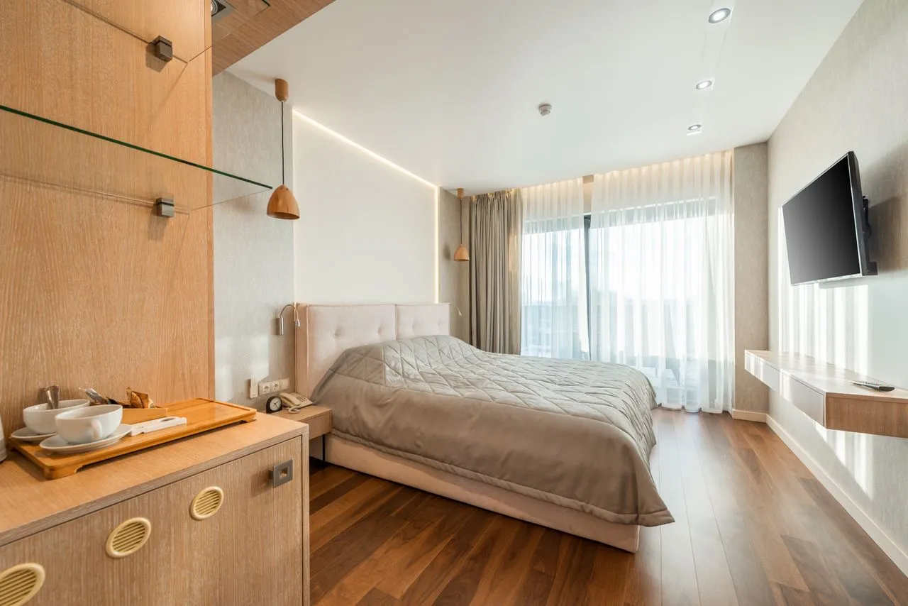 Quiet pale bedroom with integrated joinery