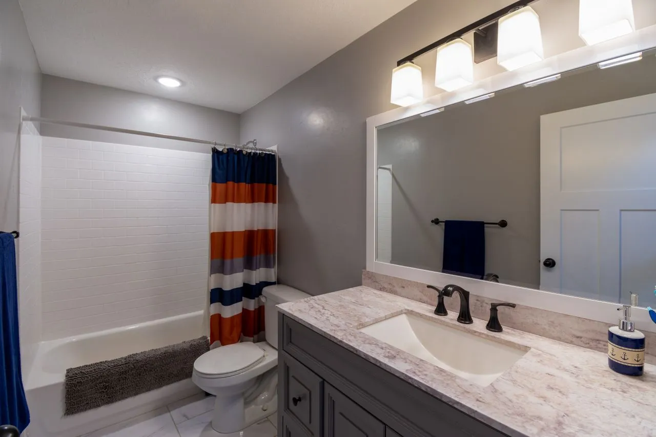 Bathroom with stone vanity and restrained fittings