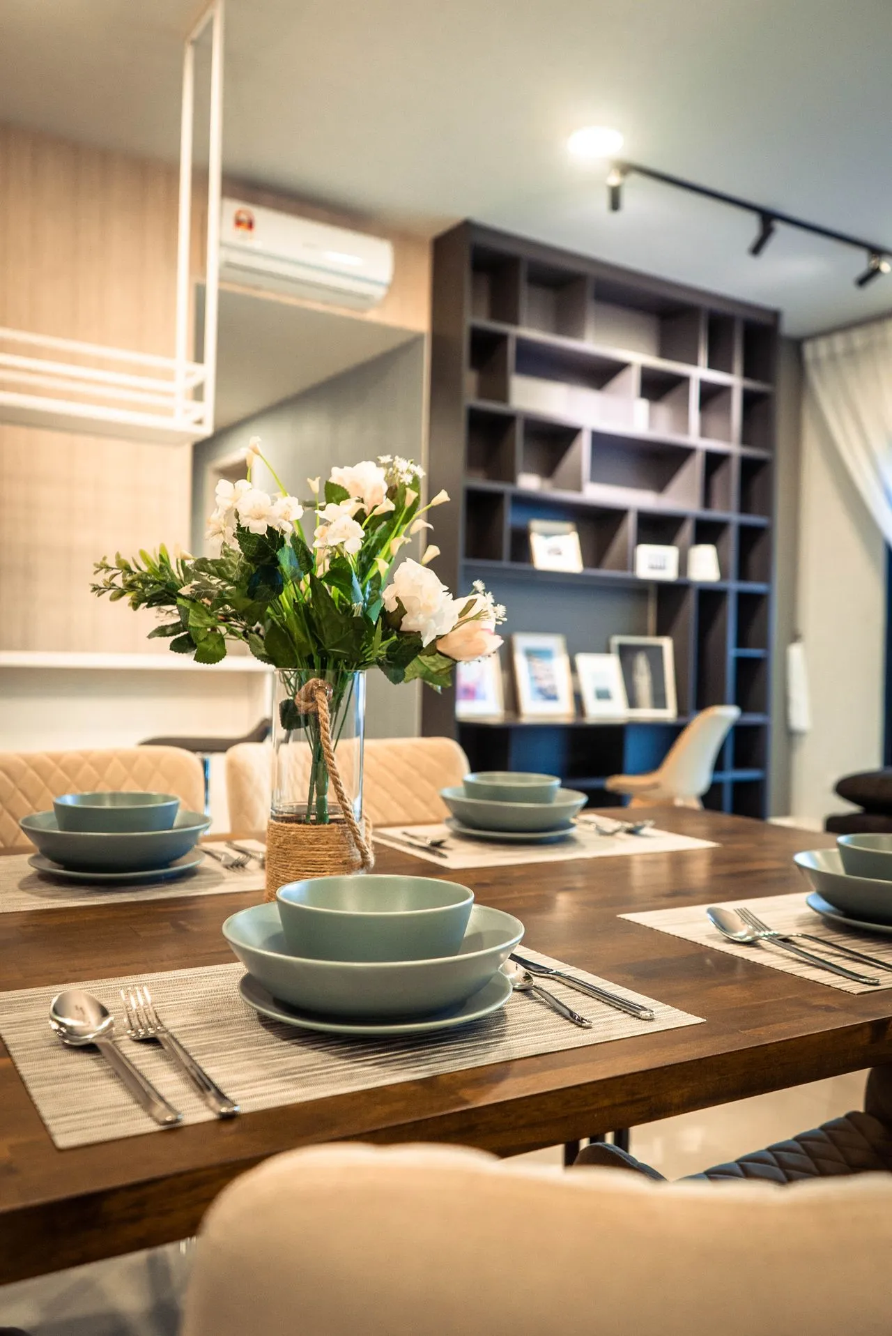 Table setting beside open shelving