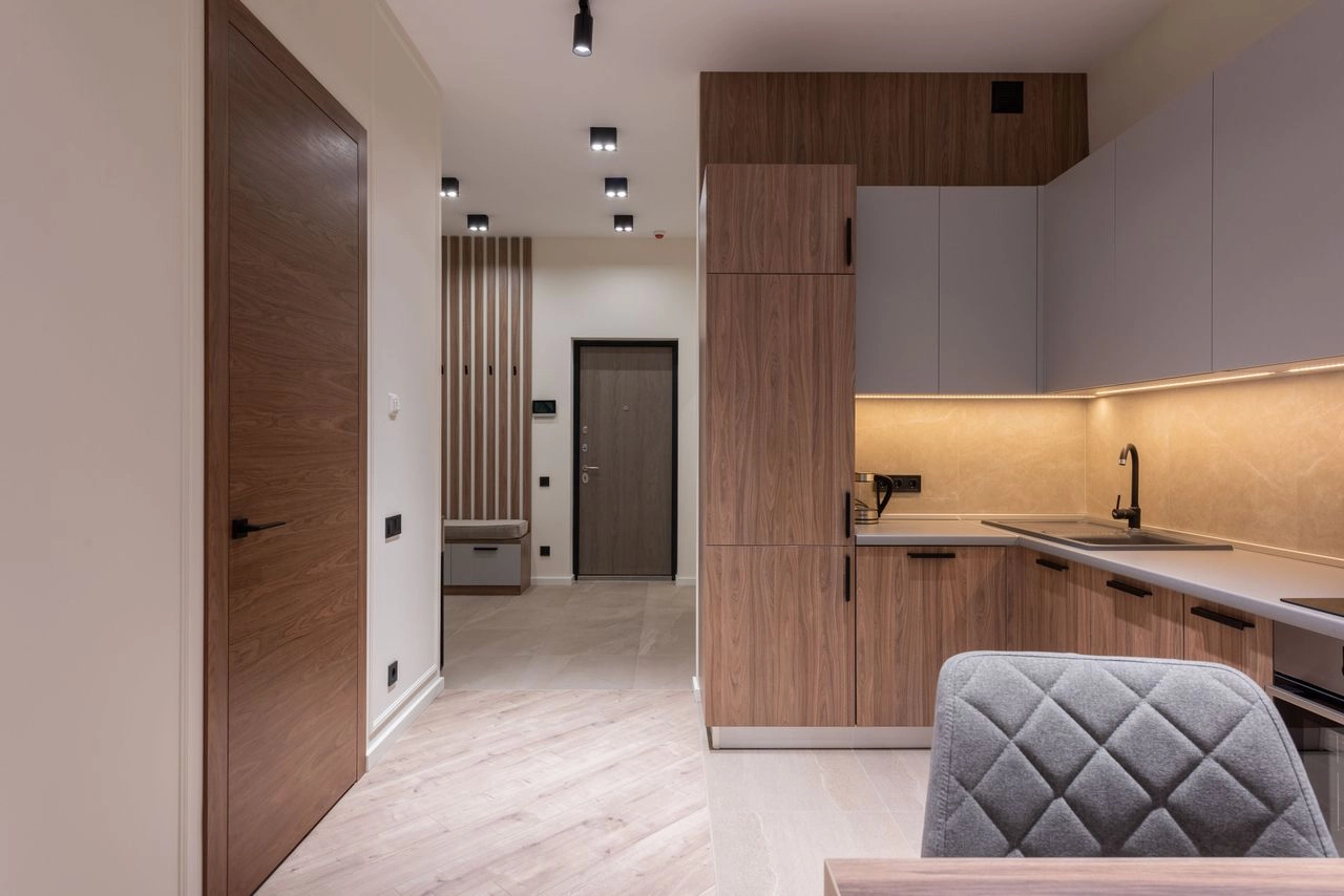 Apartment entrance with integrated timber kitchen joinery