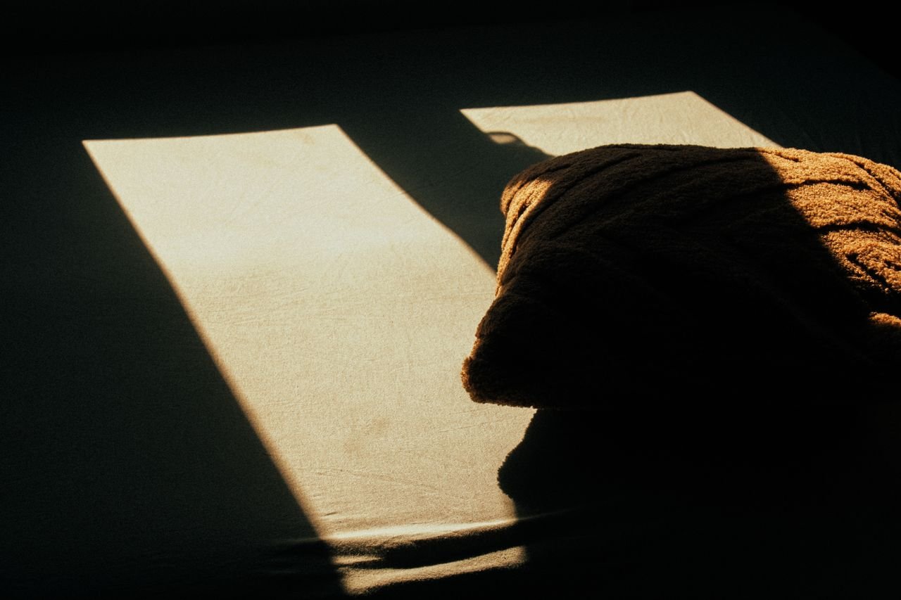 Textured fabric crossed by a sharp beam of sunlight