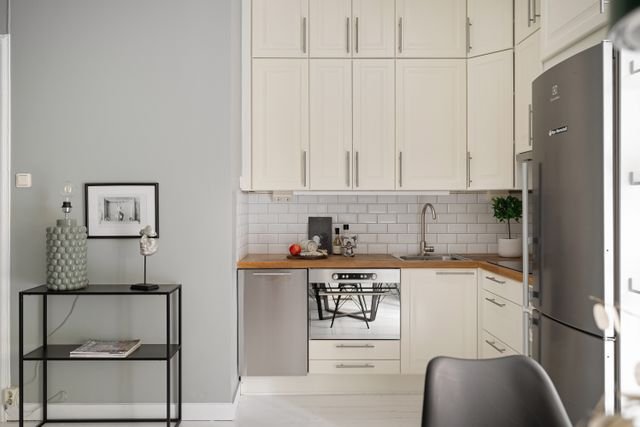 Compact pale kitchen receiving direct morning light