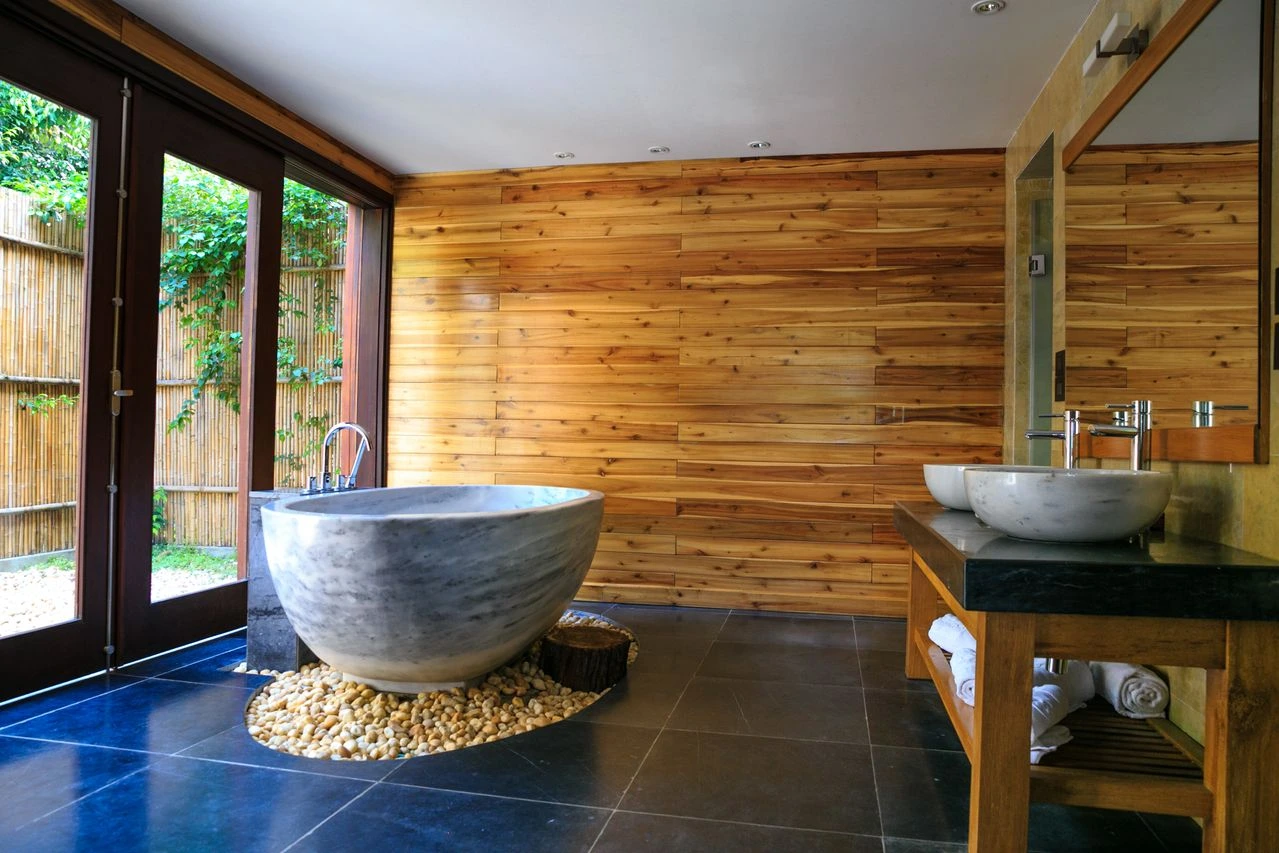 Timber-lined ensuite with a freestanding stone bath