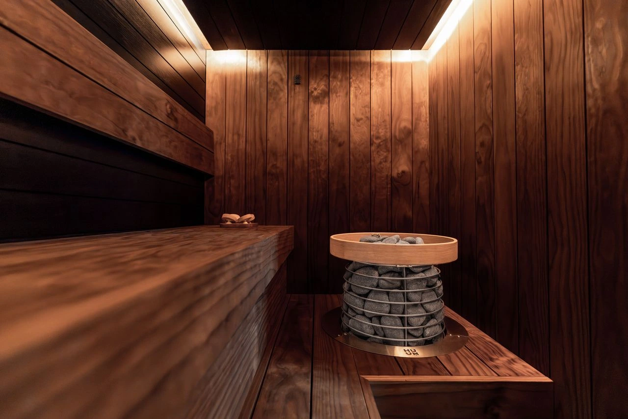 Timber sauna interior with stone heater