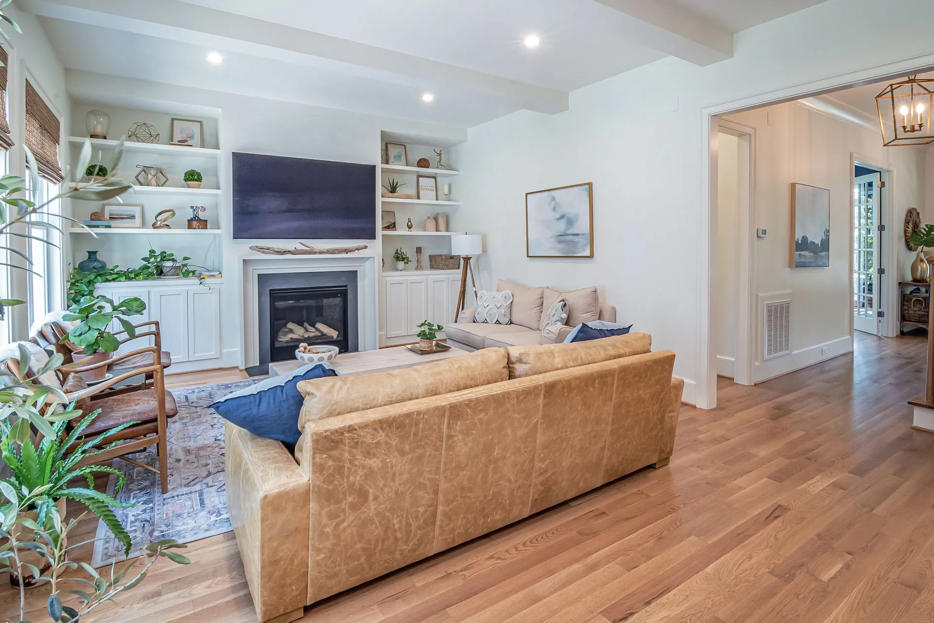 Bright domestic living room with integrated shelving and art