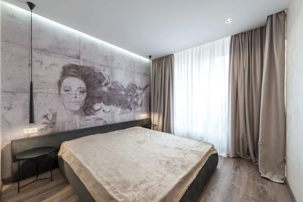 Bedroom with a large monochrome portrait mural