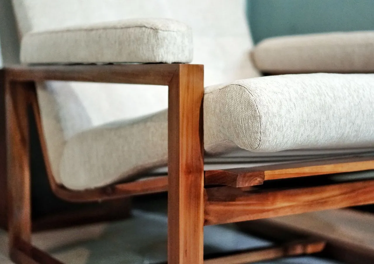 Timber chair arm and soft upholstery detail