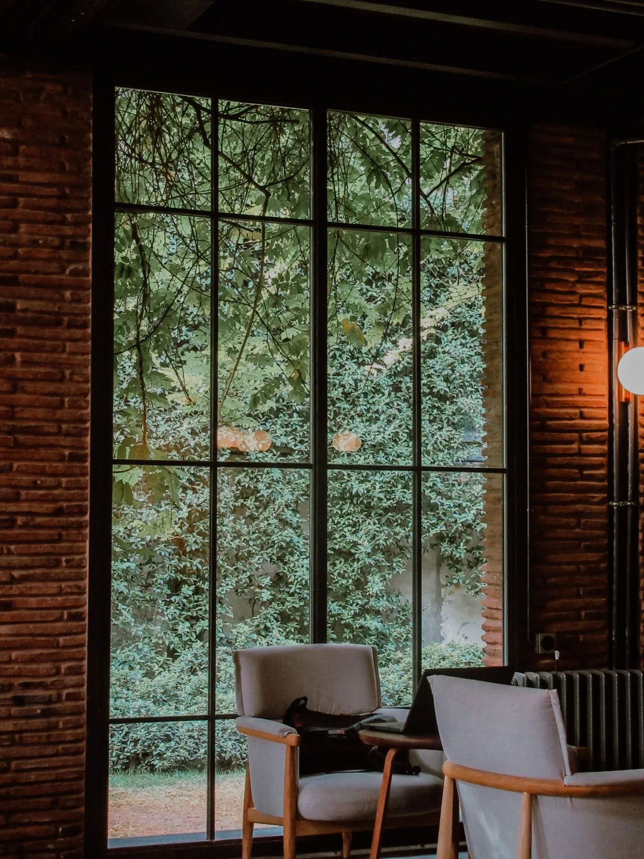 Tall garden window set within textured brick