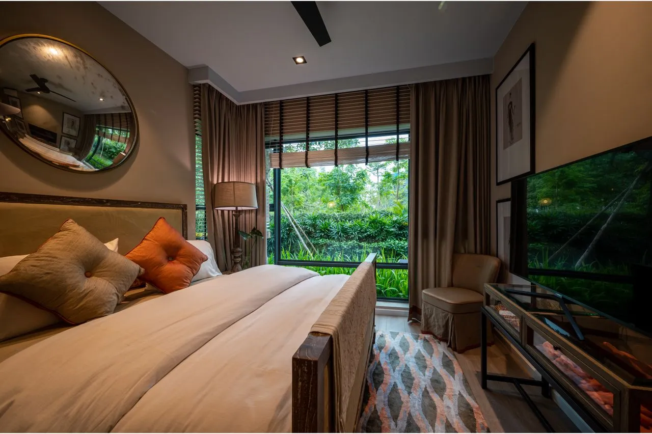 Bedroom opening toward dense garden planting